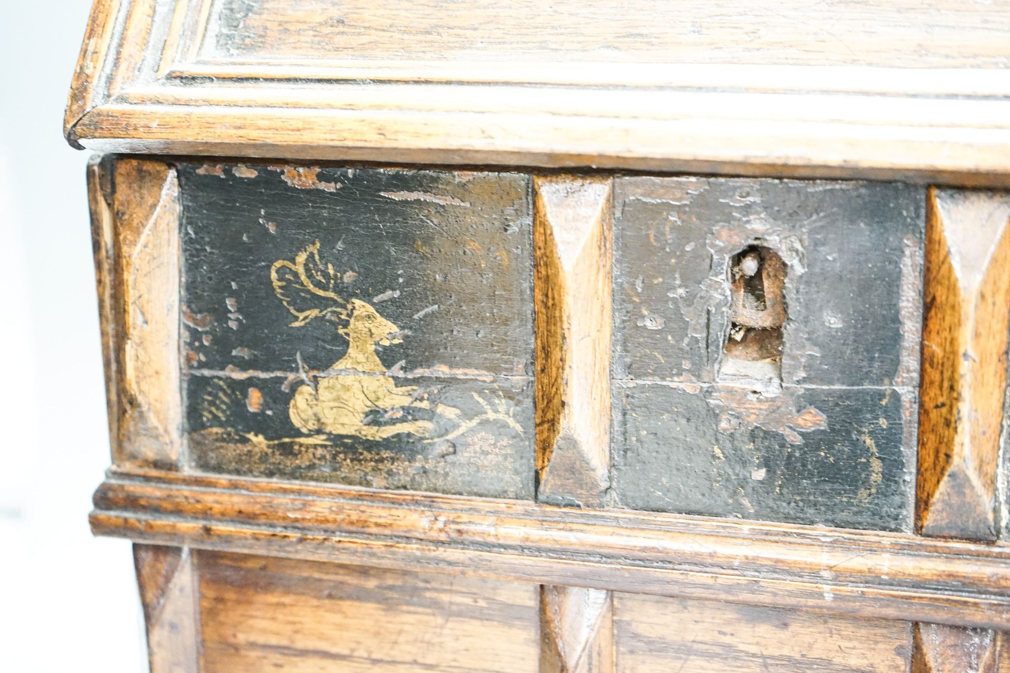 An unusual early 18th century Continental painted chestnut, oak and walnut table-top trunk with concealed drawers 38cm